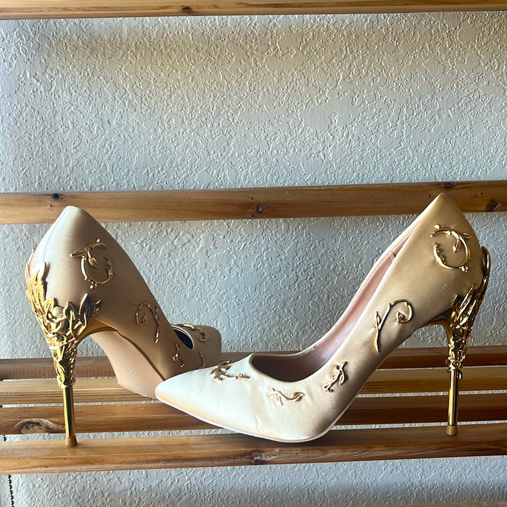 Gold detailed stiletto pumps, champagne colored satin exterior, pointed toes